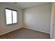 Neutral carpeted bedroom with bright window and blinds at 7089 Oberling Bay Ave, Las Vegas, NV 89113