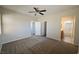 Carpeted bedroom offering neutral walls and multiple windows, with attached bathroom and closet at 7089 Oberling Bay Ave, Las Vegas, NV 89113