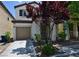 Charming two-story home featuring a well-manicured front yard and attached garage at 7089 Oberling Bay Ave, Las Vegas, NV 89113