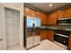 A kitchen featuring stainless steel appliances, wood cabinets, and a pantry at 7089 Oberling Bay Ave, Las Vegas, NV 89113
