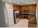The kitchen features stainless steel refrigerator, range, and wood cabinets at 7089 Oberling Bay Ave, Las Vegas, NV 89113