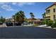 Community pool with palm trees, green fence and landscaping at 7089 Oberling Bay Ave, Las Vegas, NV 89113