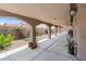 An expansive covered back patio featuring an arched design with an oversized concrete area at 8021 Yellow Daisy Ave, Las Vegas, NV 89147