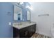 The bathroom features a double sink vanity with granite counters, framed mirrors, and modern lighting at 8021 Yellow Daisy Ave, Las Vegas, NV 89147