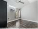 Bedroom with hardwood flooring, a window, neutral paint, and a modern ceiling fan at 8021 Yellow Daisy Ave, Las Vegas, NV 89147