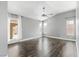This spacious bedroom has wood-look floors, a modern ceiling fan, and an exit to the backyard patio at 8021 Yellow Daisy Ave, Las Vegas, NV 89147
