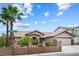 Charming single-story home featuring mature palm trees and a well-manicured front yard at 8021 Yellow Daisy Ave, Las Vegas, NV 89147