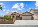 Inviting single-story home showcasing a well-maintained front yard, desert flora, and desert landscaping at 8021 Yellow Daisy Ave, Las Vegas, NV 89147