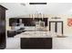 Modern kitchen with dark cabinetry, granite countertops, and pendant lighting over the island at 8021 Yellow Daisy Ave, Las Vegas, NV 89147