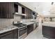 Fully equipped kitchen boasting stainless steel appliances, stone countertops, and functional design at 8021 Yellow Daisy Ave, Las Vegas, NV 89147