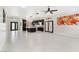 Spacious living room and kitchen with white tile flooring and stainless steel appliances at 8021 Yellow Daisy Ave, Las Vegas, NV 89147