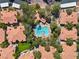 Aerial view highlighting the community pool, surrounded by lush landscaping, near residential buildings at 8409 Running Deer Ave # 203, Las Vegas, NV 89145