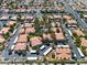 Aerial view showcasing a well-maintained community with lush landscaping, community pool and covered parking at 8409 Running Deer Ave # 203, Las Vegas, NV 89145
