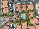 Aerial view showcasing a well-maintained community with lush landscaping, community pool and covered parking at 8409 Running Deer Ave # 203, Las Vegas, NV 89145