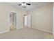 Bedroom featuring neutral carpet, a ceiling fan and two entry doors at 8409 Running Deer Ave # 203, Las Vegas, NV 89145