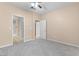 Spacious carpeted bedroom featuring two doorways and a ceiling fan, providing a comfortable retreat at 8409 Running Deer Ave # 203, Las Vegas, NV 89145