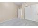 Carpeted bedroom features a double door closet and neutral walls, offering a calm and inviting space at 8409 Running Deer Ave # 203, Las Vegas, NV 89145