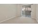 Bedroom featuring neutral carpet and a sliding glass door leading to the outdoors at 8409 Running Deer Ave # 203, Las Vegas, NV 89145