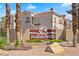 Inviting Indian Wells community entrance sign, featuring desert landscaping and a glimpse of the building's architectural details at 8409 Running Deer Ave # 203, Las Vegas, NV 89145
