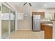 Bright kitchen with tile flooring and sliding doors and a stainless-steel refrigerator at 8409 Running Deer Ave # 203, Las Vegas, NV 89145