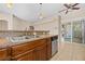 Granite countertop and stainless steel appliances in this kitchen that opens up to a living area at 8409 Running Deer Ave # 203, Las Vegas, NV 89145