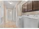 Functional laundry room with tile flooring, washer, dryer, and convenient overhead cabinet storage space at 8409 Running Deer Ave # 203, Las Vegas, NV 89145