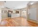 Open-concept living area featuring hardwood floors and modern lighting, connecting seamlessly to the kitchen at 8409 Running Deer Ave # 203, Las Vegas, NV 89145