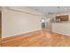 Open living room with hardwood floors leading to sliding glass doors at 8409 Running Deer Ave # 203, Las Vegas, NV 89145