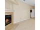Bright living room featuring neutral carpet and a fireplace with tile surround at 8409 Running Deer Ave # 203, Las Vegas, NV 89145