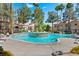 Community pool with lounge chairs and palm tree landscaping at 8409 Running Deer Ave # 203, Las Vegas, NV 89145