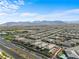 Expansive aerial view of community featuring lush landscaping and mountain views at 8668 Hartmont St, Las Vegas, NV 89166