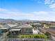 Expansive aerial perspective of a community with multiple homes, pools, and mountain views in the distance at 8668 Hartmont St, Las Vegas, NV 89166