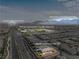 Aerial view of home in Primary-planned community with views of the mountains and clubhouse at 8668 Hartmont St, Las Vegas, NV 89166