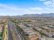 Stunning aerial view of the community, green spaces, and distant mountains at 8668 Hartmont St, Las Vegas, NV 89166
