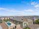 Inviting backyard with a private swimming pool, green lawn, and desert landscape, great for relaxation at 8668 Hartmont St, Las Vegas, NV 89166