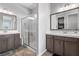 Dual vanity bathroom showcasing a walk-in shower with glass enclosure at 8668 Hartmont St, Las Vegas, NV 89166
