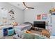 Bedroom with carpet, ceiling fan, window with shutters, a daybed and wall art at 8668 Hartmont St, Las Vegas, NV 89166