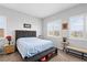 Comfortable bedroom featuring a queen size bed, bench and bedside table at 8668 Hartmont St, Las Vegas, NV 89166
