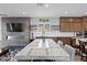 The dining area features a stylish table with seating, adjacent to a modern kitchen and cozy living room at 8668 Hartmont St, Las Vegas, NV 89166