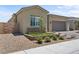 Inviting single-story home with desert landscaping, retaining walls, and a two-car garage at 8668 Hartmont St, Las Vegas, NV 89166