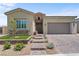Beautiful desert-landscaped home featuring a paver driveway and walkway to the front door at 8668 Hartmont St, Las Vegas, NV 89166