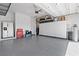 Spacious garage with epoxy floors, ample storage, and room for multiple vehicles or a workshop at 8668 Hartmont St, Las Vegas, NV 89166
