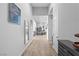 Bright hallway with wood-look tile flooring, leading to the living areas at 8668 Hartmont St, Las Vegas, NV 89166