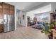 Open floor plan with kitchen view into living room features stainless steel appliances and ample space at 8668 Hartmont St, Las Vegas, NV 89166