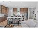 Open-concept living room with a modern kitchen and comfortable sofa seating at 8668 Hartmont St, Las Vegas, NV 89166