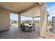 Covered patio with brick pavers, outdoor furniture, a view of the mountains, and a meticulously maintained yard at 8668 Hartmont St, Las Vegas, NV 89166