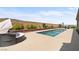 Backyard with a pool, spa, manicured landscaping, and a cozy outdoor lounging area for relaxation at 8668 Hartmont St, Las Vegas, NV 89166