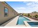 Backyard view showcasing a modern swimming pool with spa and lounge area at 8668 Hartmont St, Las Vegas, NV 89166