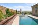 Stunning backyard pool with sleek lounge chairs and well-manicured landscaping for outdoor relaxation at 8668 Hartmont St, Las Vegas, NV 89166