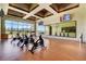 Modern spin studio with stationary bikes, wall mirrors, mounted TV screens, and scenic views at 8668 Hartmont St, Las Vegas, NV 89166
